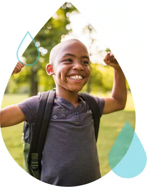 A young hypertension patient wearing a backpack smiles and flexes both biceps.